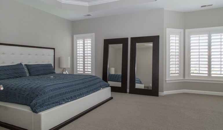 White shutters in a minimalist bedroom in San Diego.